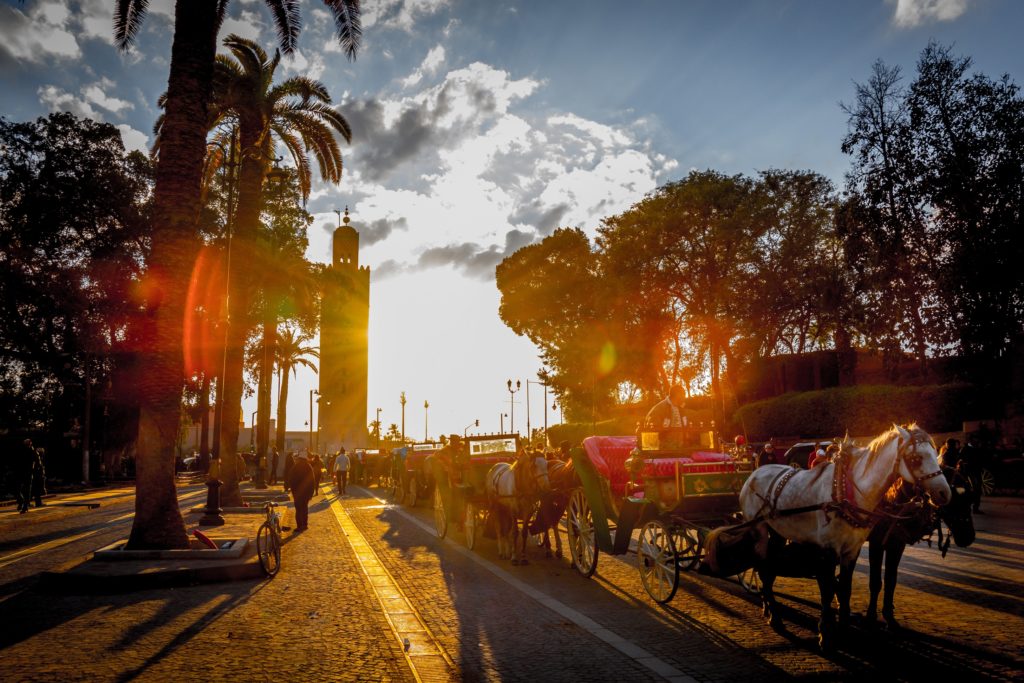 Koutoubia minaret and horse-drawn carriages near Jemaa El Fna square in Marrakech